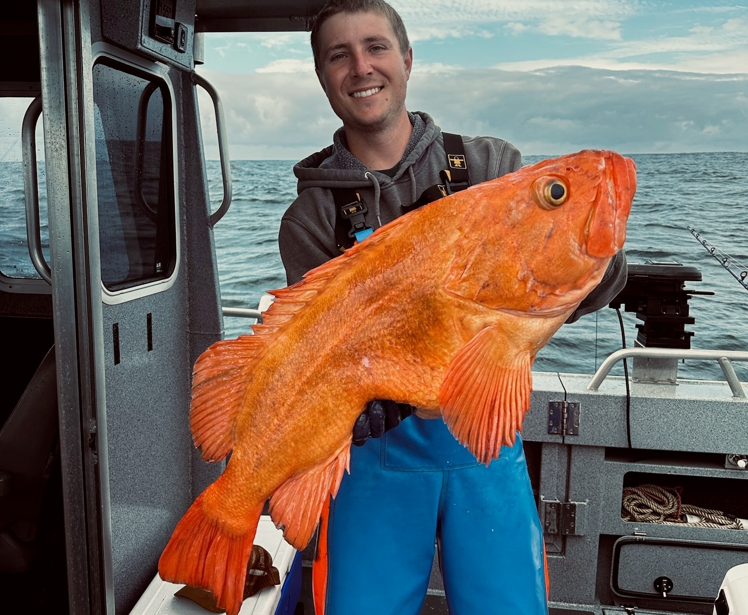 Angler holding a large rockfish caught in Alaska